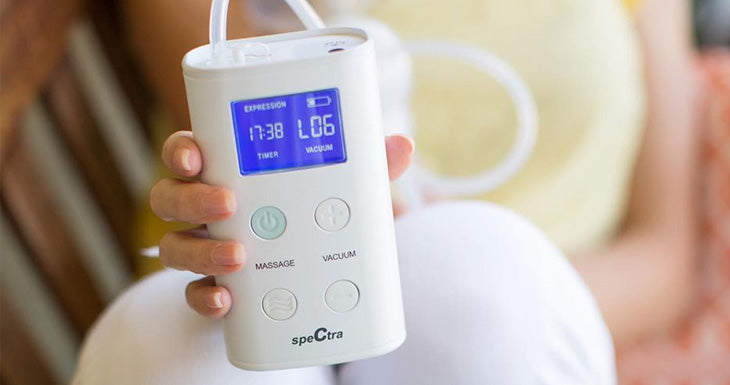 mom holding 9 plus breast pump