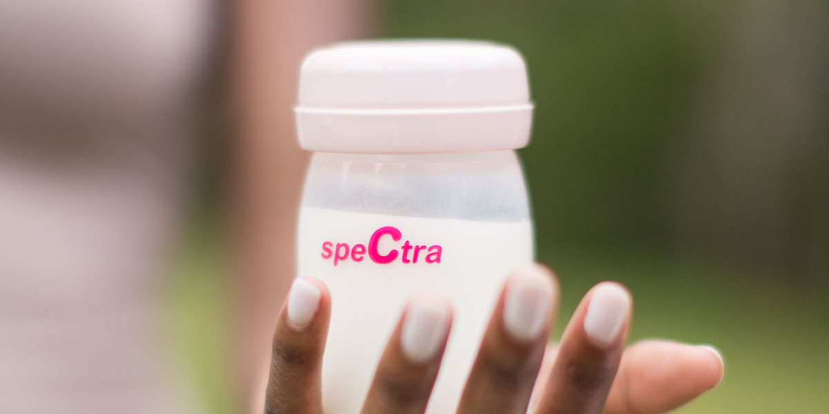 mom holding breast milk bottle